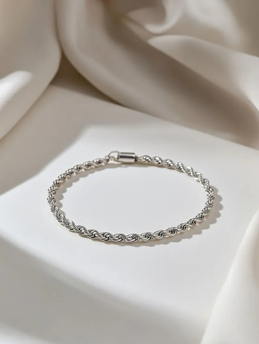 Silver bracelet on a soft beige fabric background
