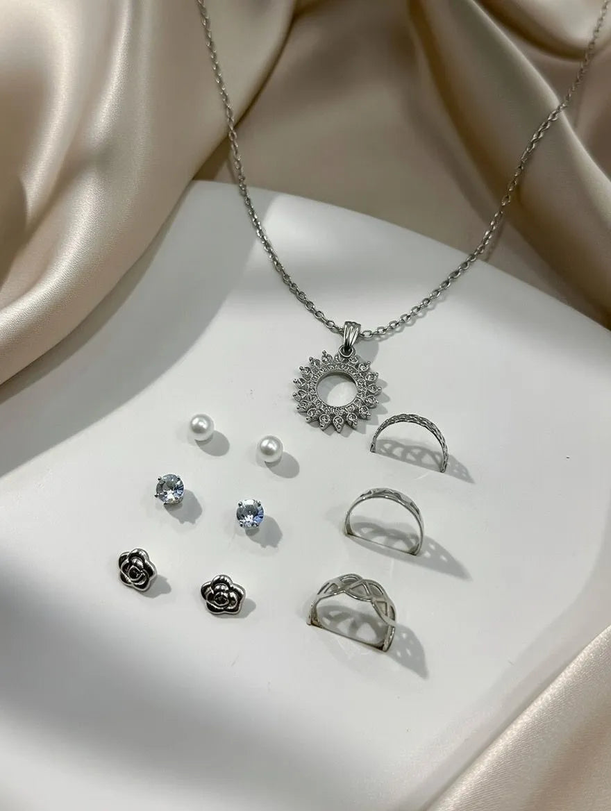 Aureva 7-piece jewelry set including gold-tone necklace, 3 pairs of tops earrings, and 3 stacking rings - Women's fashion Pakistan