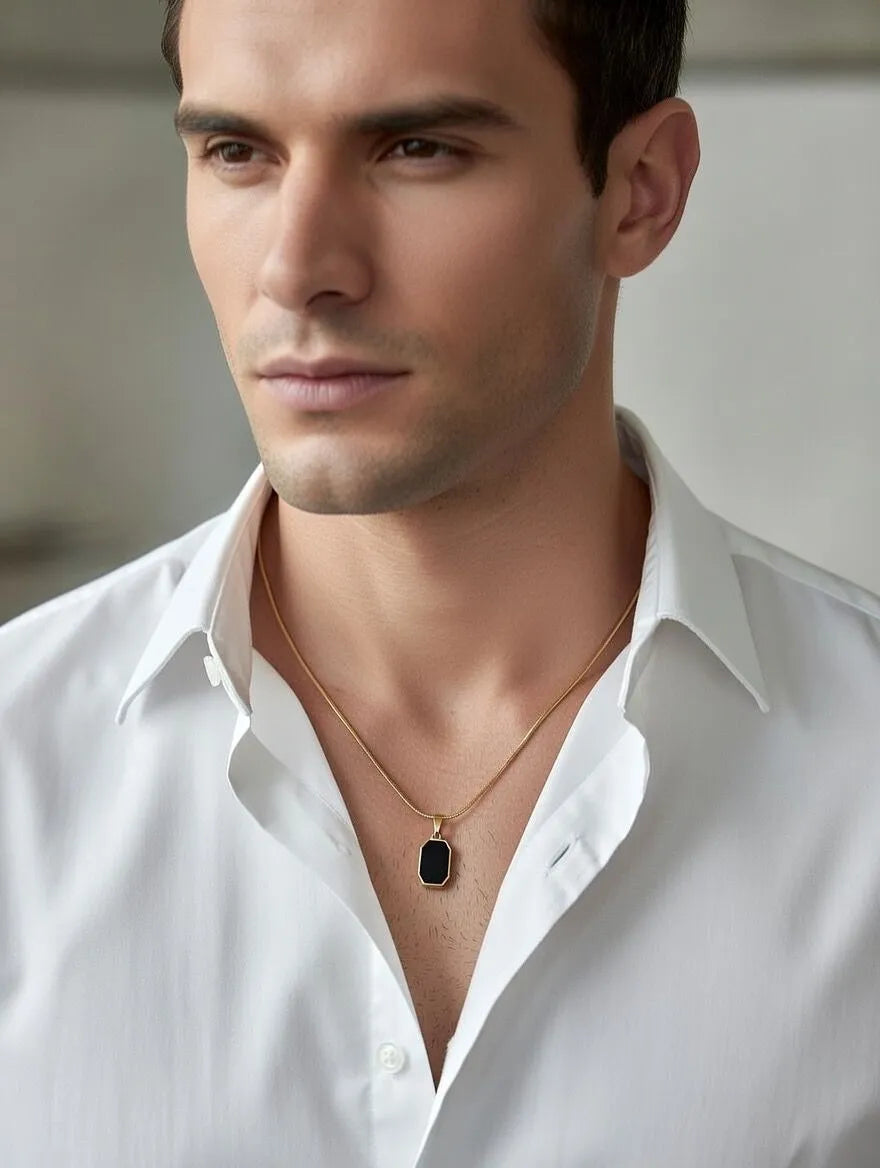 Unisex gold-toned circular pendant with engraved