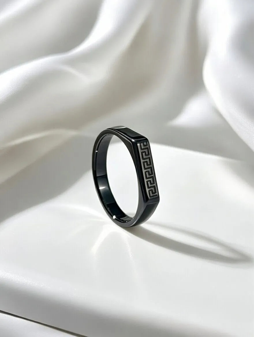 A polished gold men's signet ring with a rectangular silver-toned face