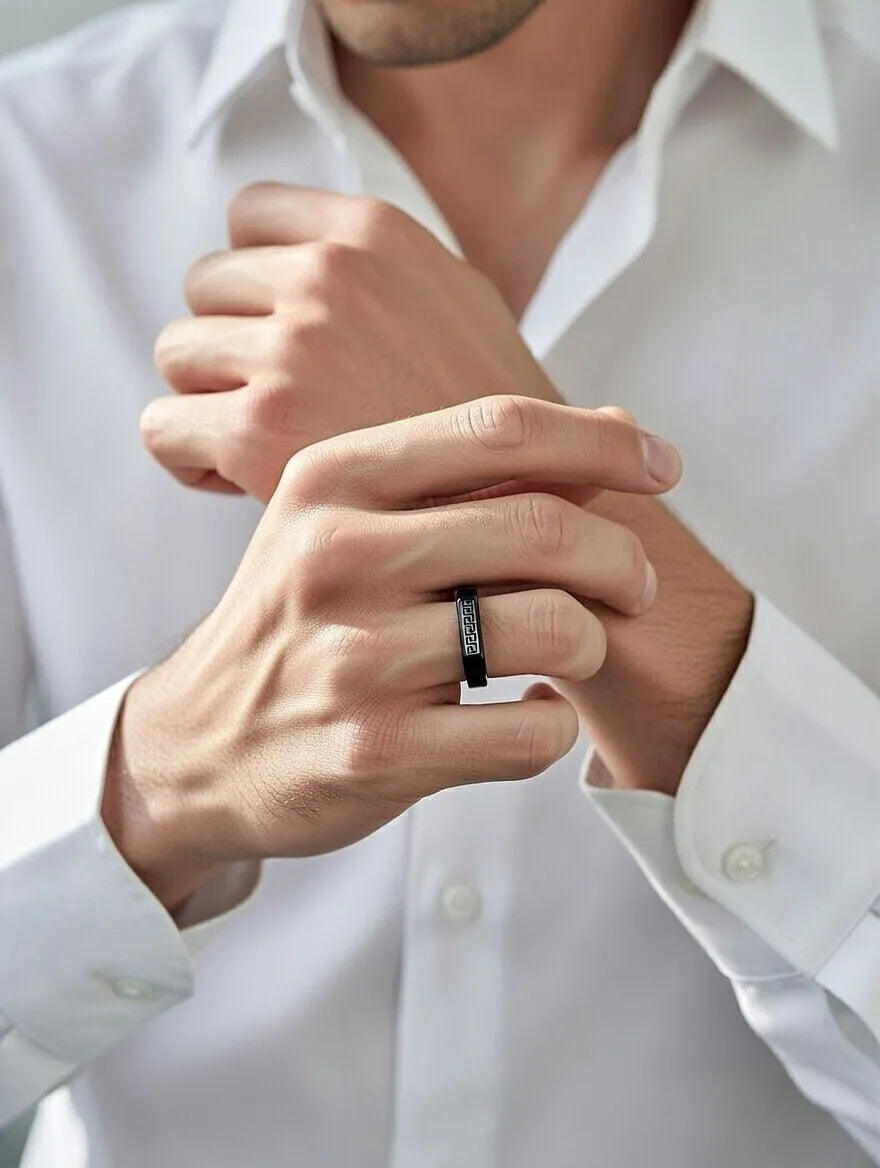 A polished gold men's signet ring with a rectangular silver-toned face