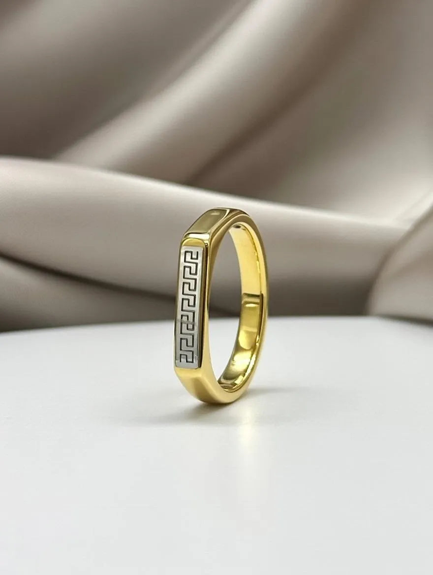 A polished gold men's signet ring with a rectangular silver-toned face