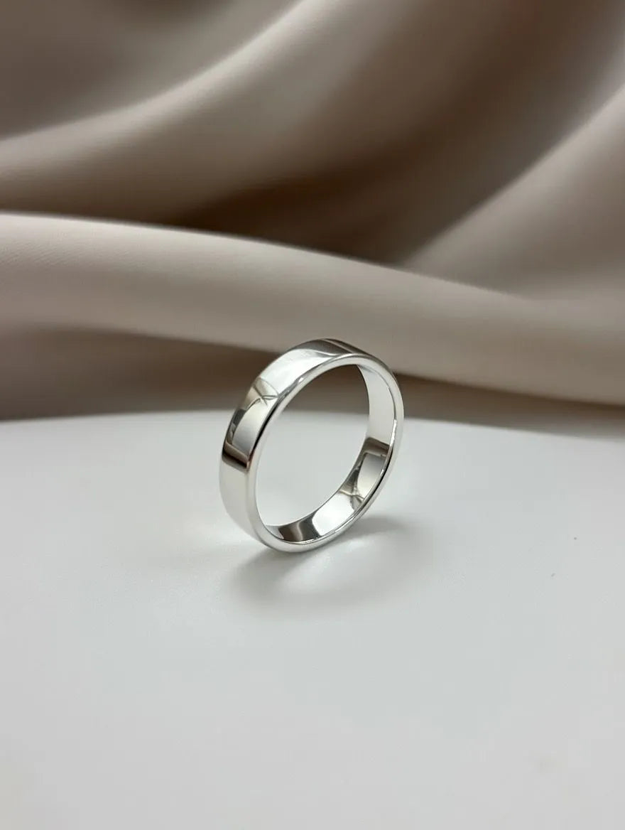 Silver ring on a beige fabric background