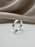 Silver ring on a beige fabric background