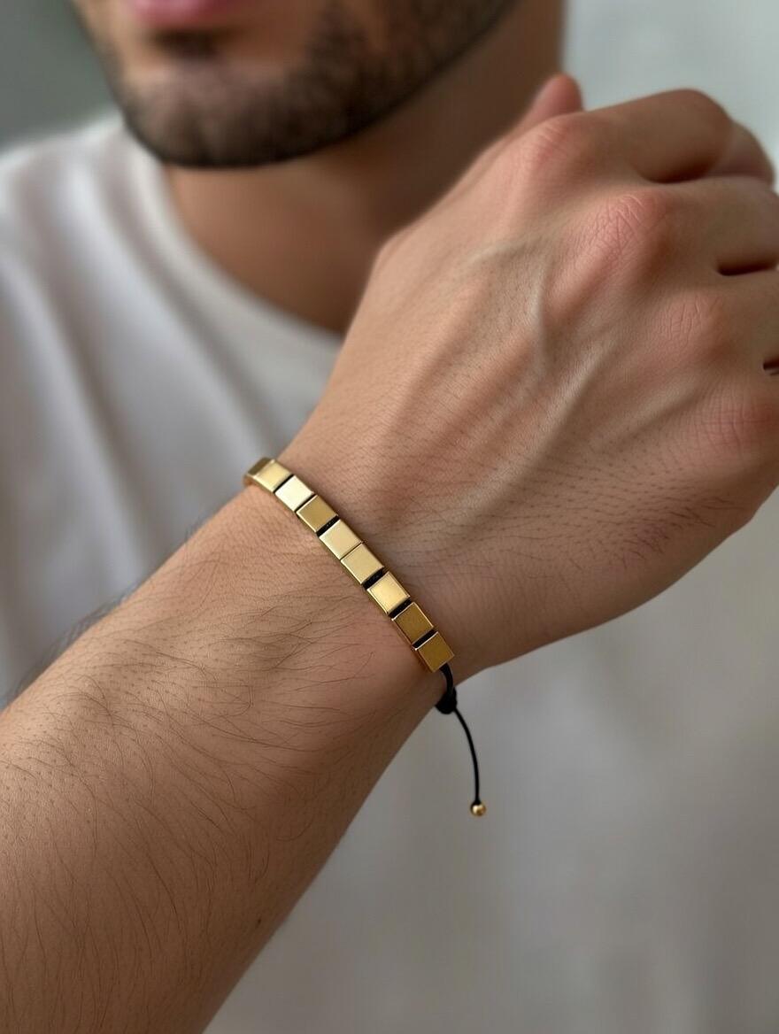 Gold bracelet on a wrist with a blurred background