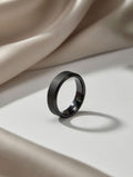 Black ring on a light beige fabric background