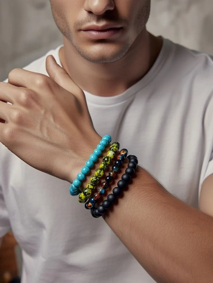 four different beaded bracelets on their wrist