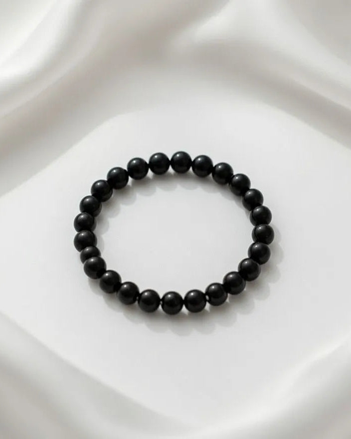 Unisex stretch bracelet featuring polished round black onyx beads