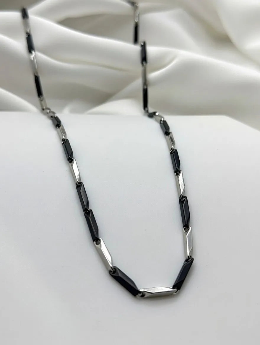silver and matte black rectangular bar links