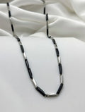 silver and matte black rectangular bar links
