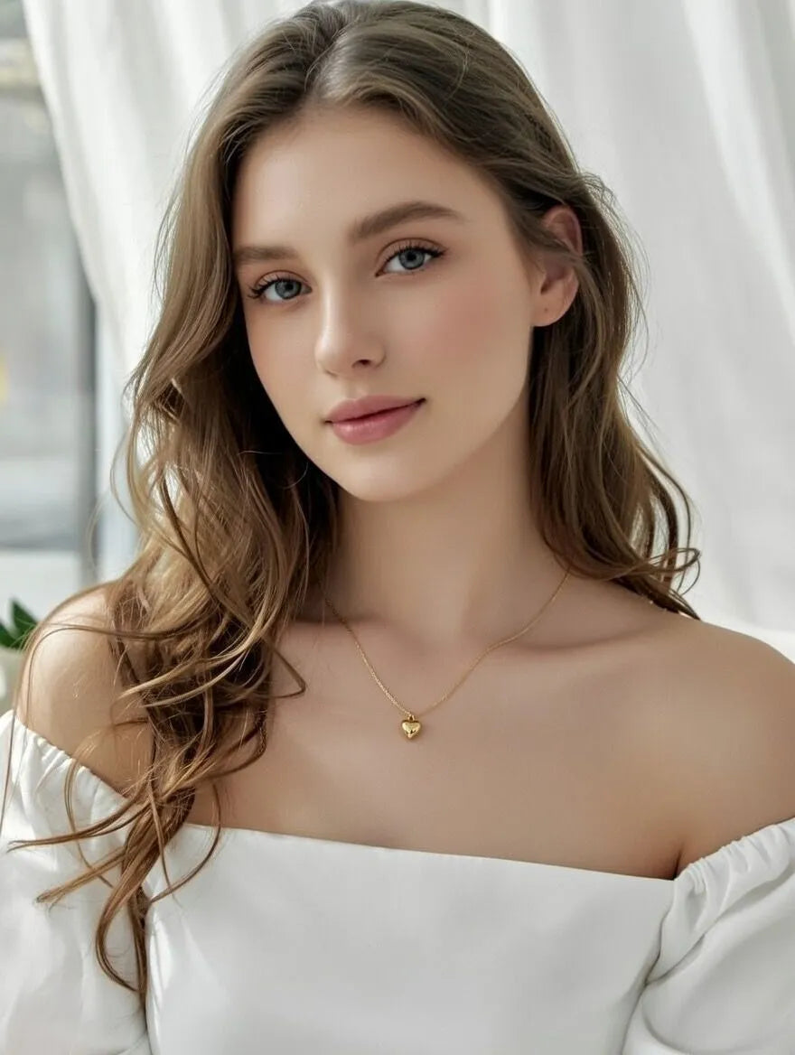 a polished 3D heart charm on a delicate chain,